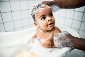 Cute Black Baby getting a bath